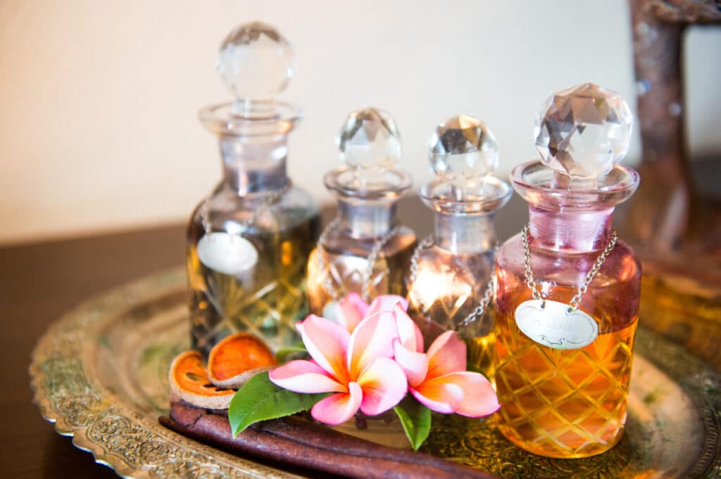 Attar Bottles in many Flavor with flowers on a plate