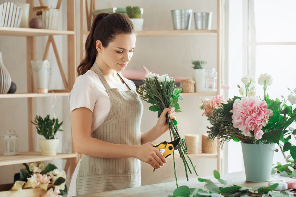 A Woman Cutting Flower Stems is the Useful Tips to Keep Flowers Fresh