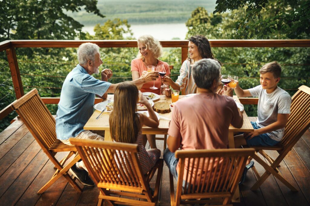 Family having dinner at restaurant with a forest background