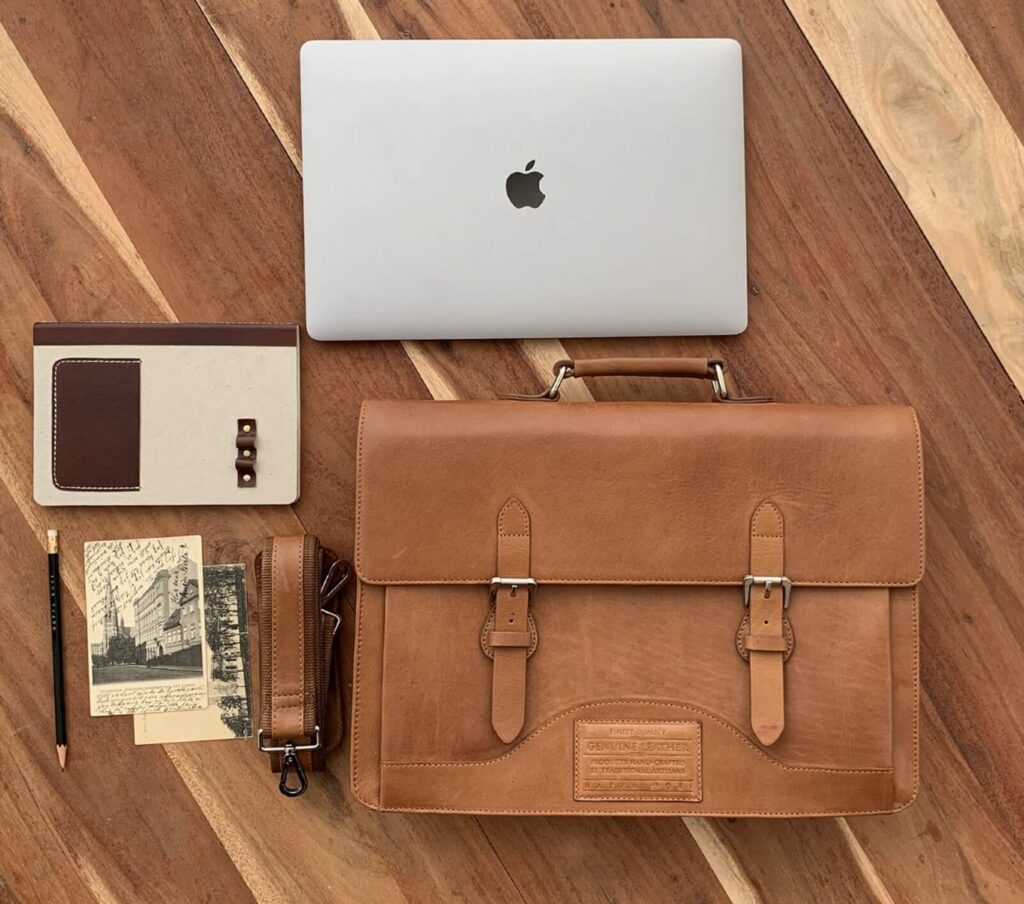 Laptop with bag, notebook & pencil are the best Farewell Gifts for Your Boss