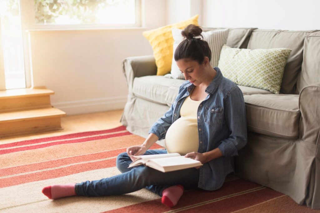 Pregnant women reading baby books
