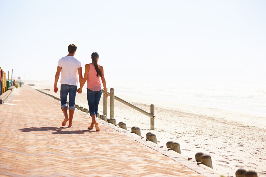 Couple walking beside a sandy beach