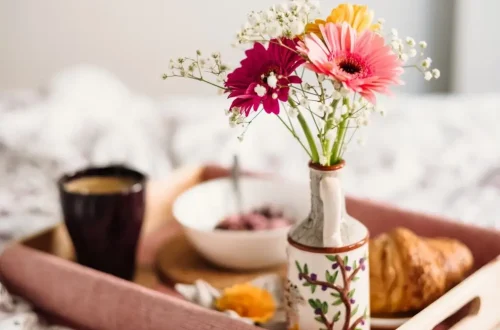 Flowers in a Vase in a tray with tea and snacks